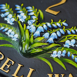 Bluebells close-up. house sign